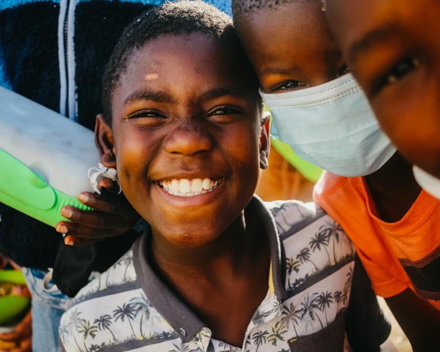 Child smiling at Kwazakhele soup kitchen