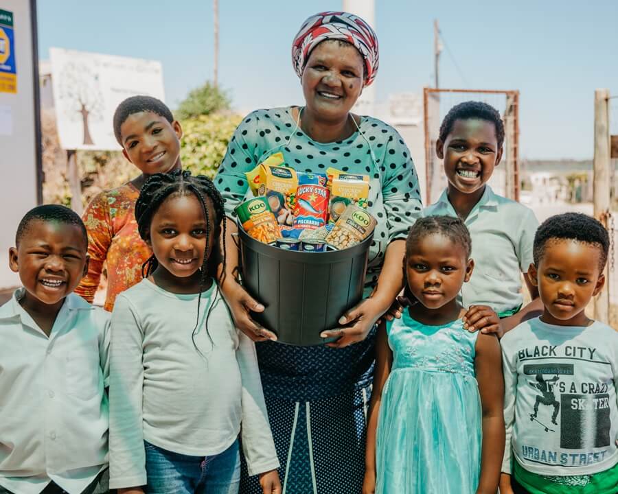 Children and parent with bucket of food